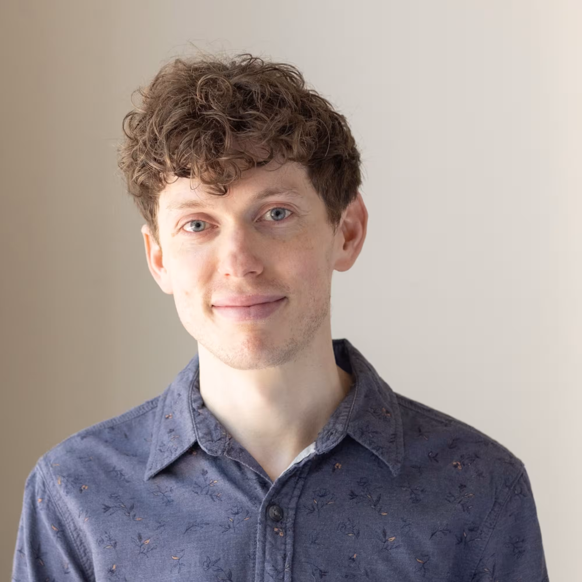 Portrait of Dr Stephen Turton, a white man with brown hair, wearing a dark blue shirt.