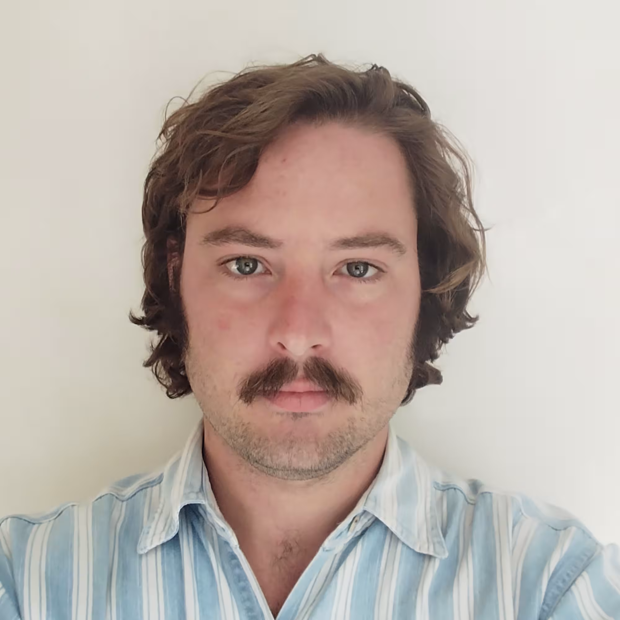 Portrait photograph of Hugh Ford, a white man with brown hair and a moustache