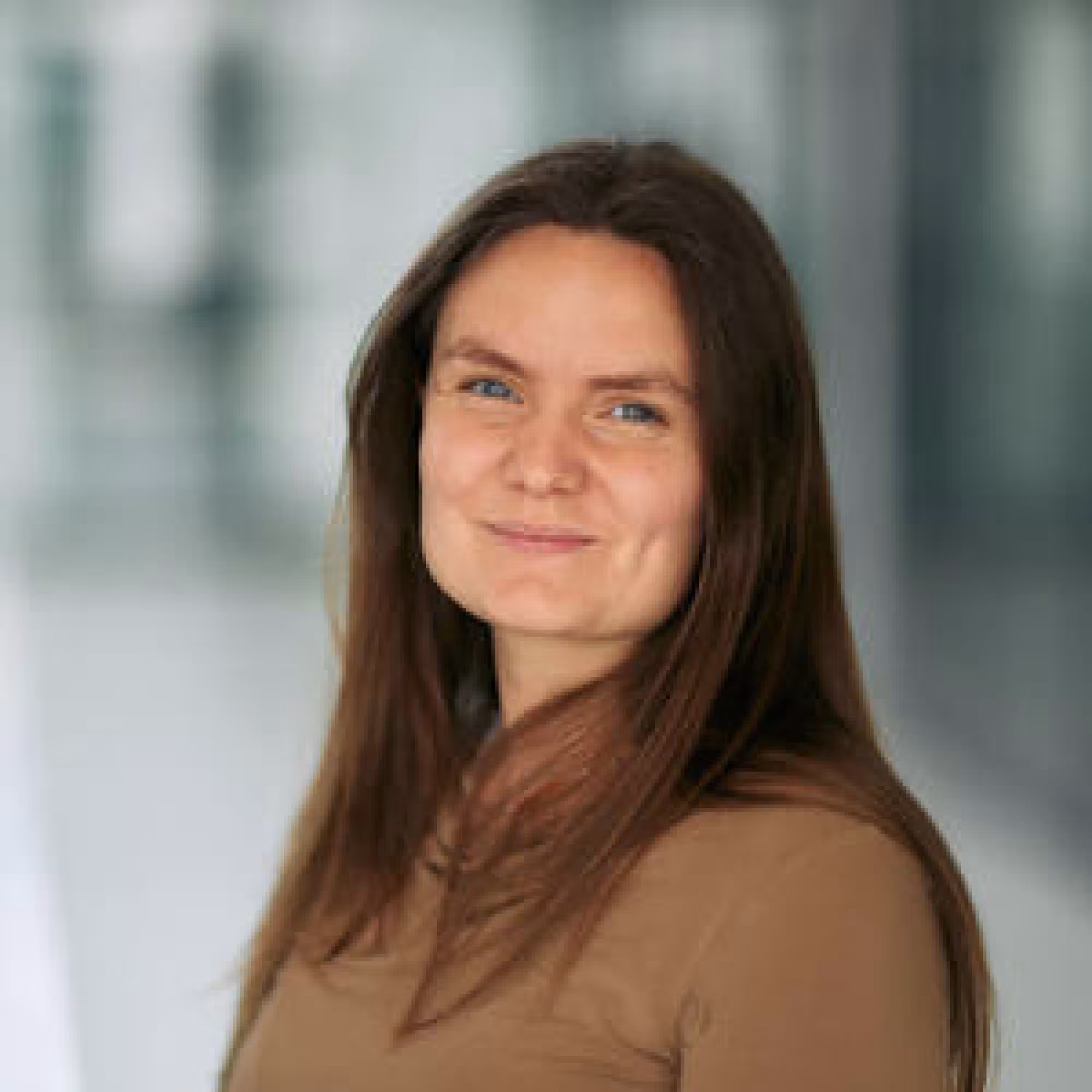 Portrait photo of Alison Andrew, a white woman with long brown hair.