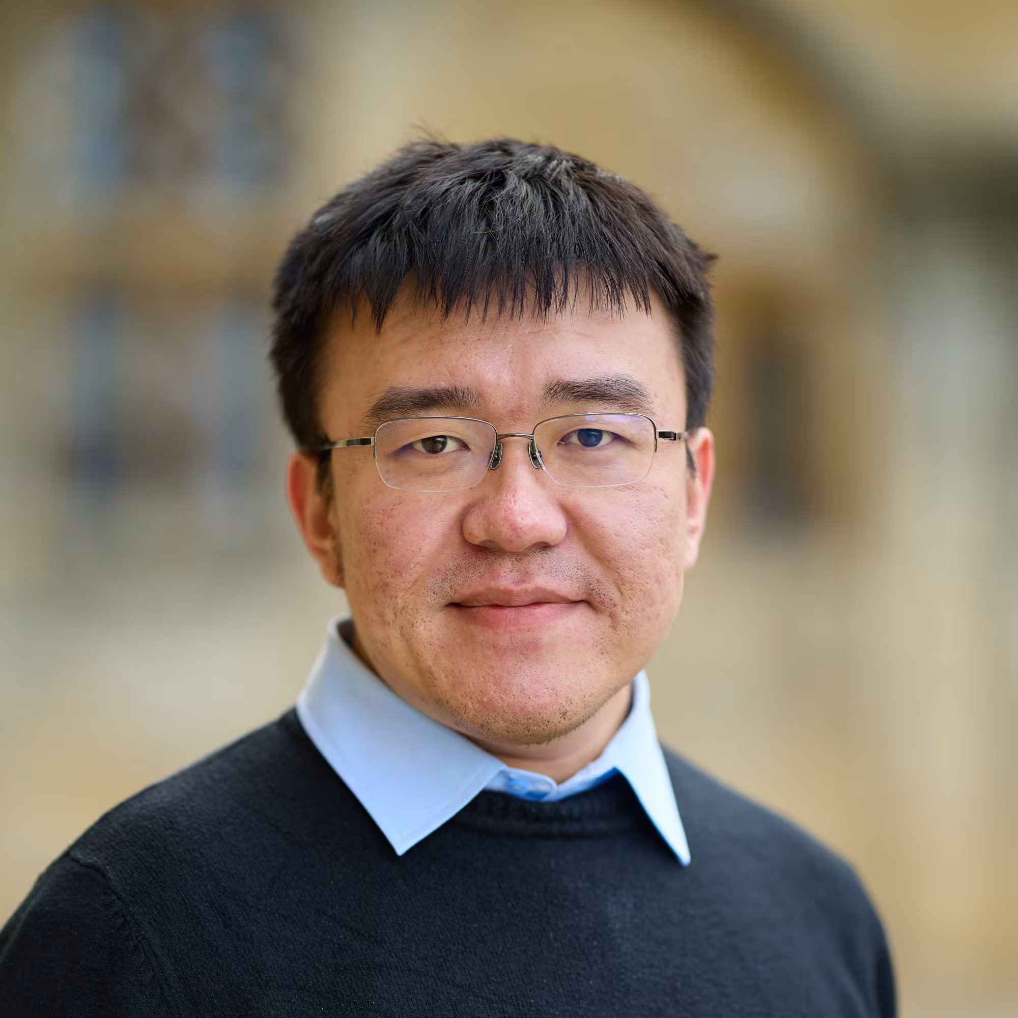 Portrait of Kaibo Hu, a man of Asian descent wearing glasses.