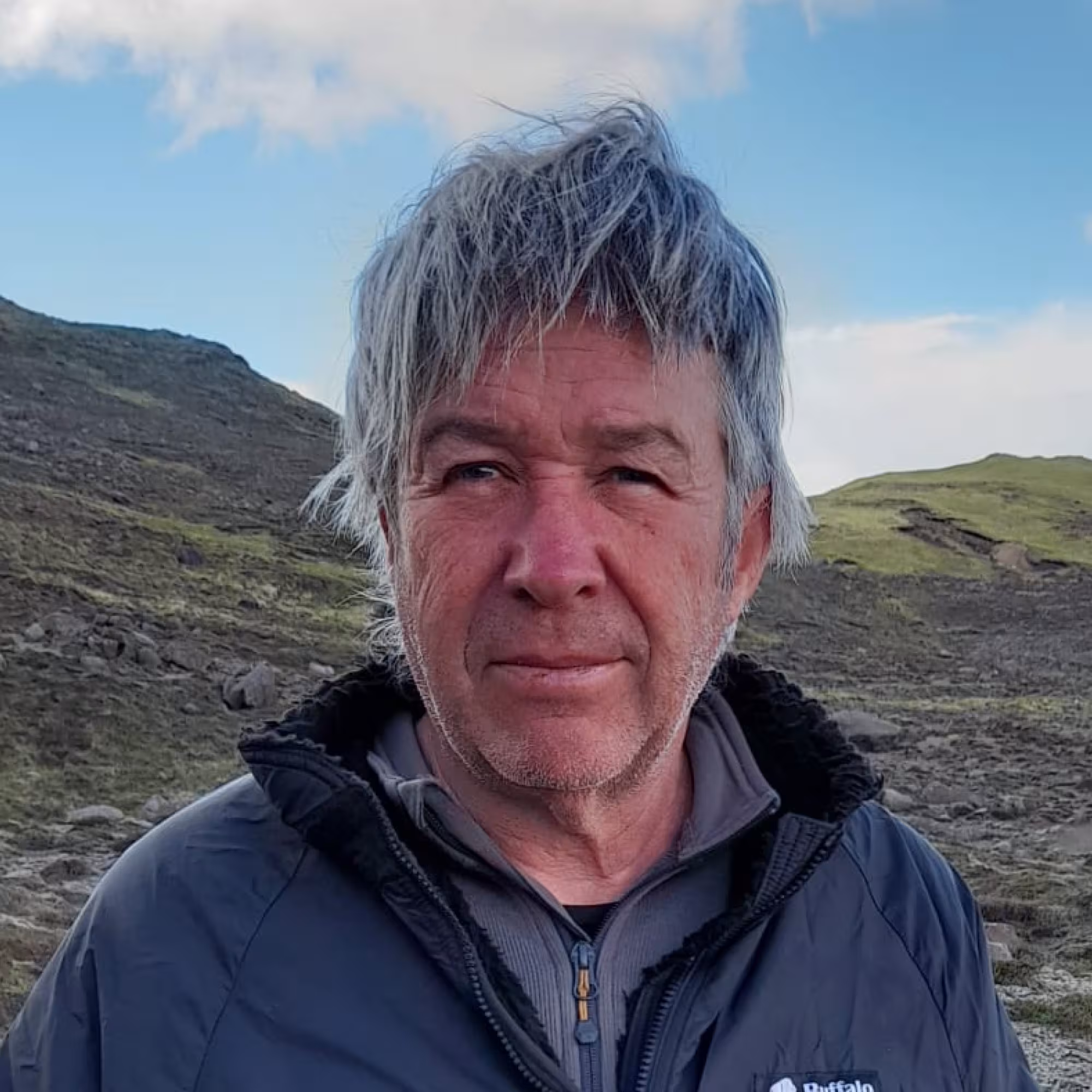 Portrait of Tim Guilford standing in front of moorland