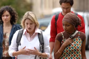 Graduate students walking and chatting along an Oxford street 
