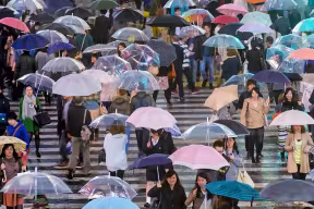 Pedestrians crossing the famous scramble crosswalk in Shibuya