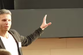 A man stands in the front of a room