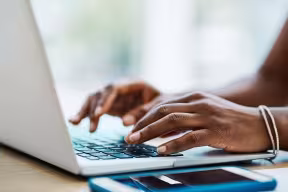 Typing on a laptop