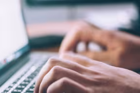 hands typing on a laptop
