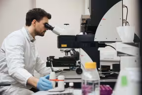 Student looking through a microscope in a Medical Sciences Division laboratory