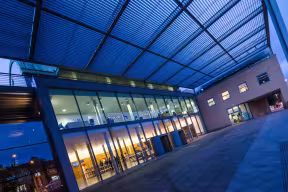 Looking into the reception area of the Saïd Business School at night.