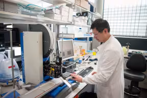 Genetic scientist screening protein crystals.