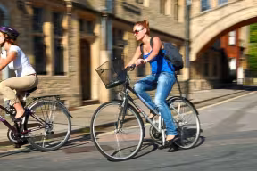Cyclists passing Hertford Bridge on Catte Street
