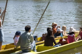 Families punting on the river during Eights Week, Oxford