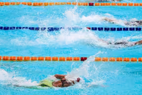 Swimmers competing in a pool