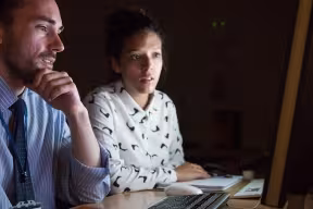 Researchers review data on a computer