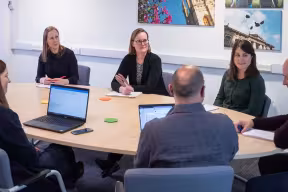 A group of staff in a meeting room