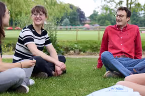 Students sat talking in the Botanic Gardens