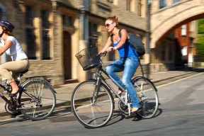 Cyclists passing Hertford Bridge on Catte Street