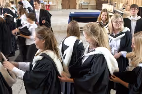 BA graduands adjusting hoods on Degree Day, Oxford, UK