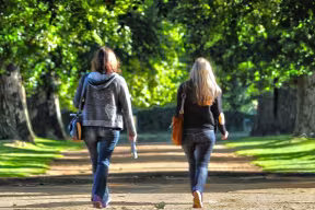 Walkers in Christ Church Meadow on a summers day