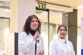 three students wearing lab coats