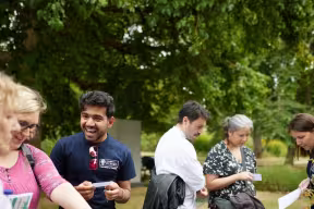 A group of people working together outside taking part in research