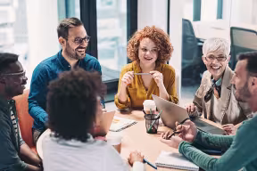 people sitting around a table and talking