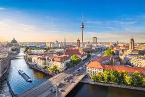 Aerial view of Berlin skyline with the famous TV tower and the Spree river in beautiful evening light at sunset, Germany.
