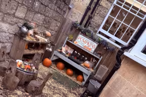 Pumpkins and straw on the ground in the Mansion house nursery garden
