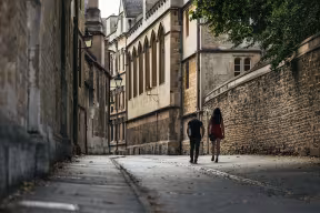 Students walking down an Oxford street.