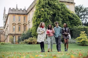 STUDENTS CHATTING IN THE NEW COLLEGE GARDENS