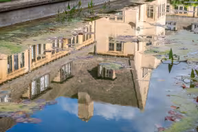 REFLECTION OF COLLEGE BUILDINGS IN POND AT NUFFIELD COLLEGE