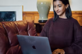 Student on a laptop in the JCR at New College