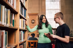 Library staff helping student