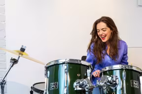 Student playing a drum kit