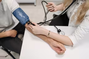 A Healthcare Worker Measuring a Patient's Blood Pressure