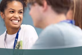 a student talking to two others