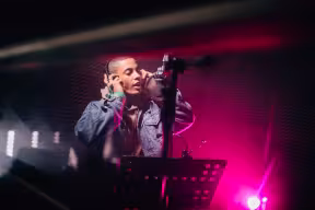 Musician singing and recording songs in professional music studio