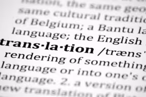  Close-up of a dictionary page with the word “translation” in bold, followed by its phonetic spelling and definition text.