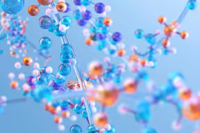 Abstract illustration of chemical molecules, seen as coloured spheres joined together by short rods. 