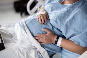Expectant mother in hospital bed.