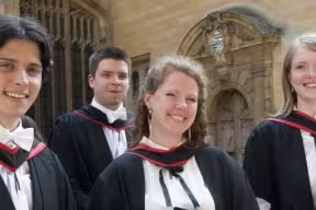 three students at their graduation