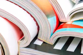 Close up of stack of open magazines