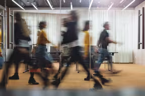 people walking behind glass