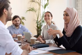 People talking and smiling around a table