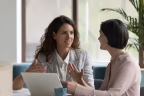 Two people talking in the workplace