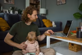 Father multitasking working from home with daughter