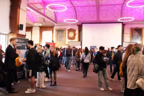 Students and employers network at a busy careers fair in the Examination Schools