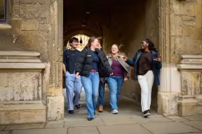 STUDENTS WALKING AND CHATTING NEAR THE OLD SCHOOLS QUADRANGLE