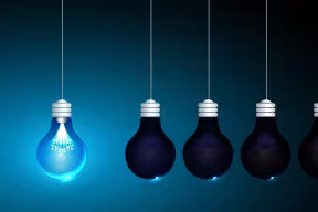 Five hanging light bulbs against a dark blue-to-black gradient background. The bulb on the far left is brightly illuminated with a blue glow, while the other four remain unlit, symbolizing a standout idea, innovation, or inspiration.