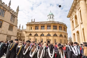 Graduates celebrate the end of the degree ceremony outside the Sheldonian Theatre