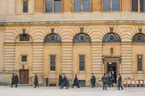 Graduates exit the Sheldonian Theatre to collect their hoods after their conferral of degrees